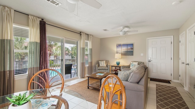 tiled living room featuring ceiling fan