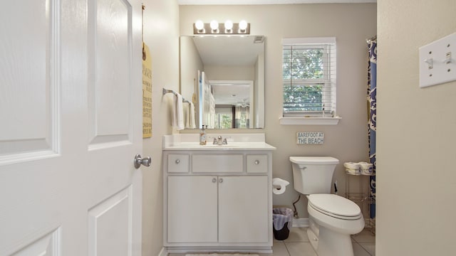 bathroom featuring vanity with extensive cabinet space, toilet, and tile floors