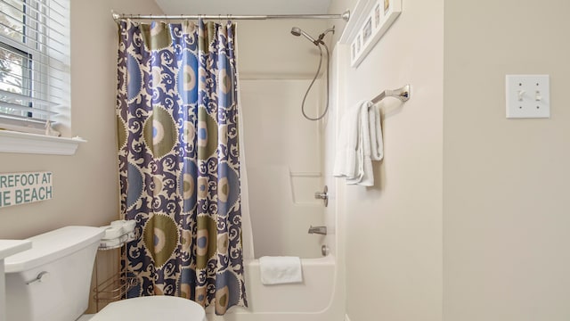 bathroom with toilet and shower / tub combo