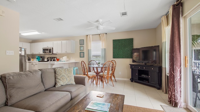 tiled living room with ceiling fan