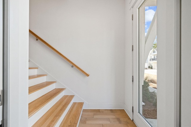 stairs with light hardwood / wood-style floors