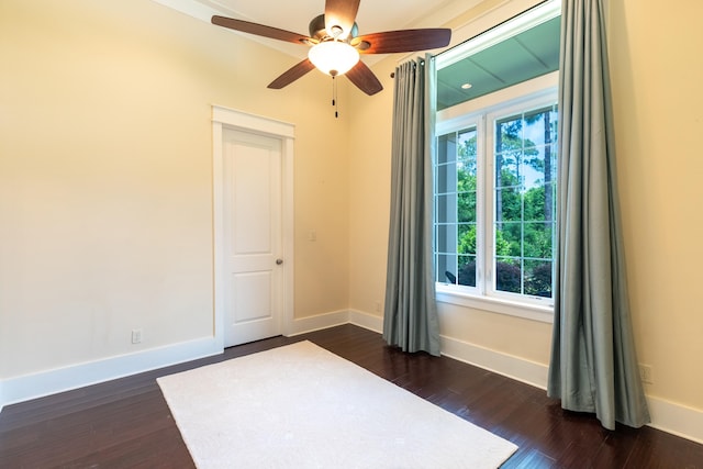 unfurnished room featuring ceiling fan and dark wood-type flooring