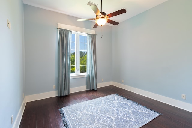 empty room with ceiling fan and dark hardwood / wood-style floors