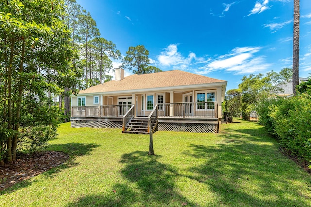 back of house with a deck and a lawn