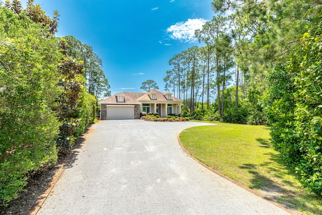 view of front of house featuring a garage and a front lawn