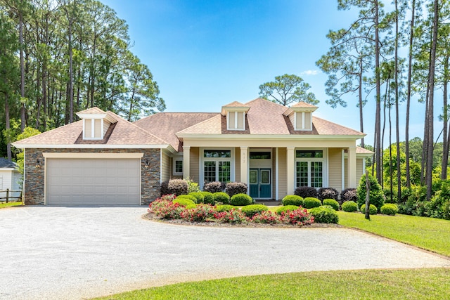 view of front of house featuring a garage and a front lawn