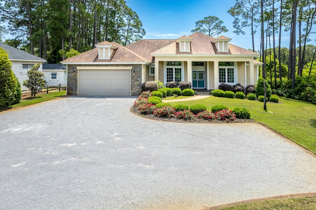 view of front of property with a front lawn, a garage, and a porch