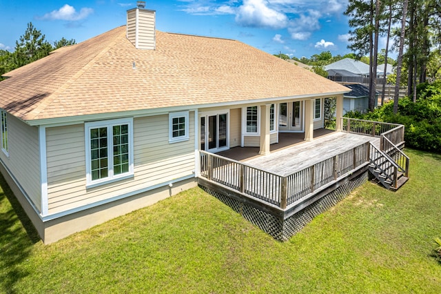 back of property with a wooden deck and a lawn