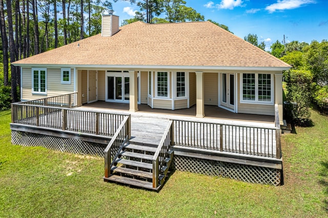 rear view of property featuring a deck and a lawn