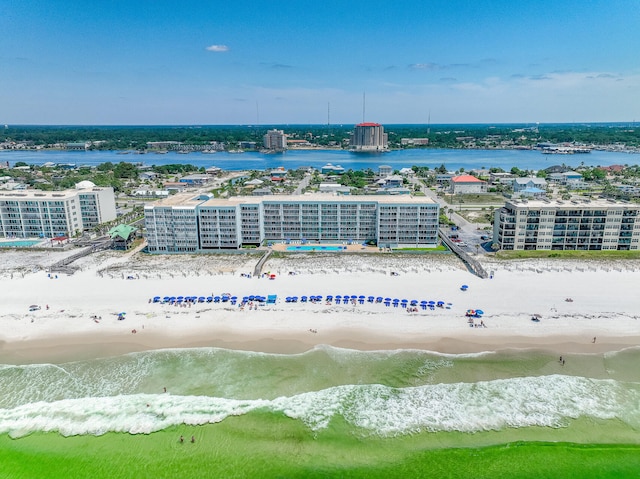 birds eye view of property featuring a water view and a beach view