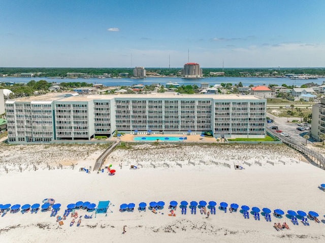 birds eye view of property featuring a water view and a beach view