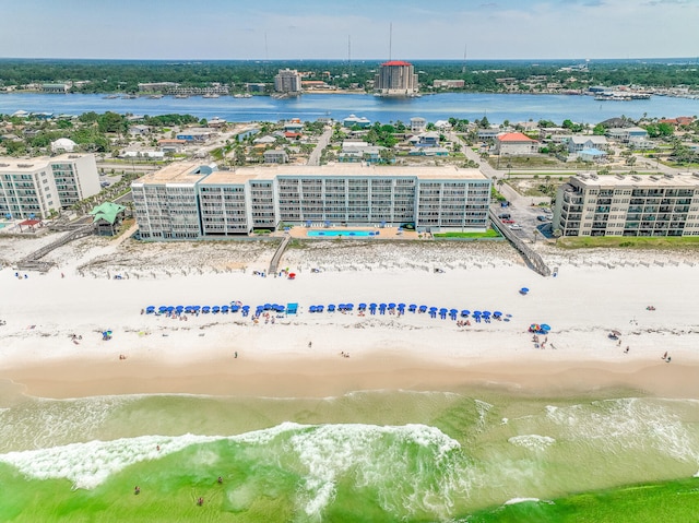 bird's eye view featuring a water view and a beach view