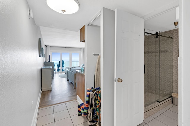 hallway with light hardwood / wood-style floors