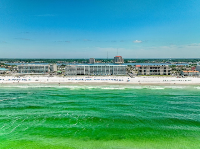 birds eye view of property featuring a beach view and a water view