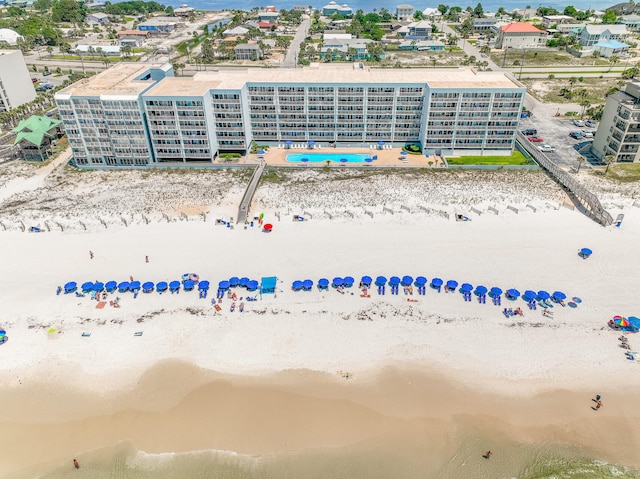 aerial view with a water view and a beach view