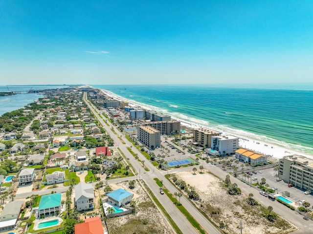 aerial view with a water view and a beach view