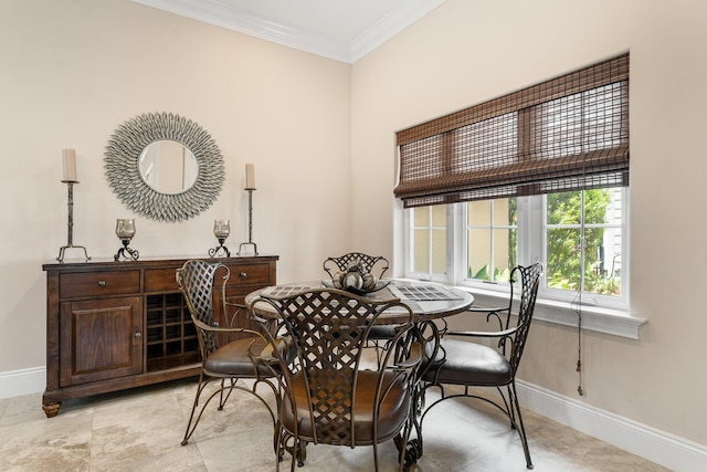 dining room featuring crown molding and light tile floors