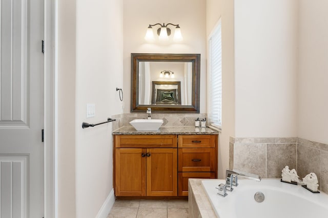 bathroom with tile floors, large vanity, and a bathtub