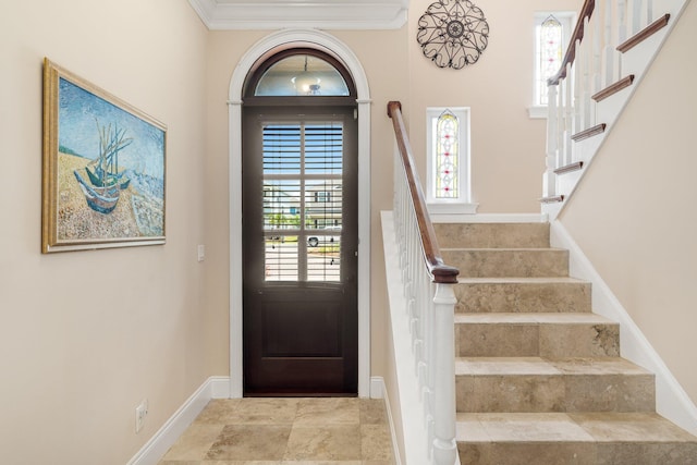 tiled foyer featuring crown molding