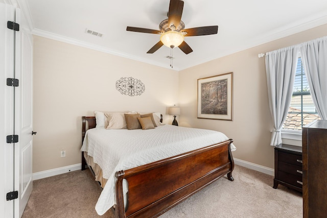 carpeted bedroom with ceiling fan and crown molding