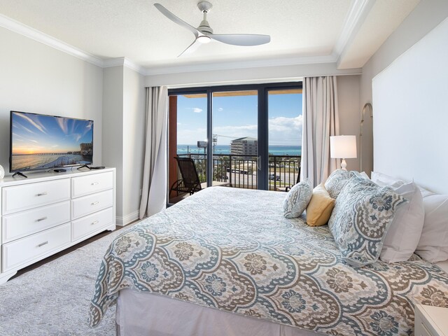 bedroom featuring ornamental molding, ceiling fan, access to outside, and a water view