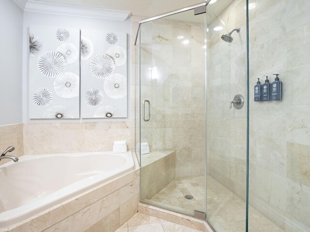 bathroom with tile floors, shower with separate bathtub, and crown molding