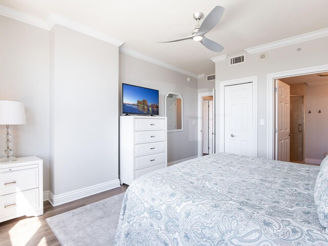 bedroom with dark hardwood / wood-style flooring, ceiling fan, and crown molding