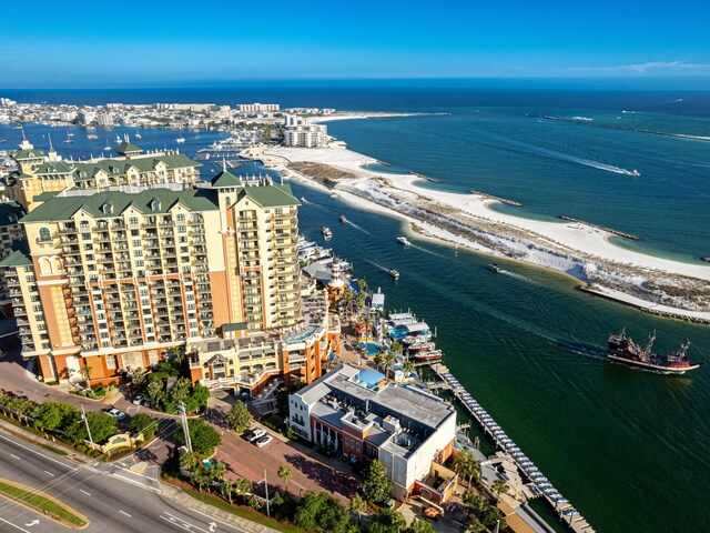 drone / aerial view featuring a water view and a view of the beach