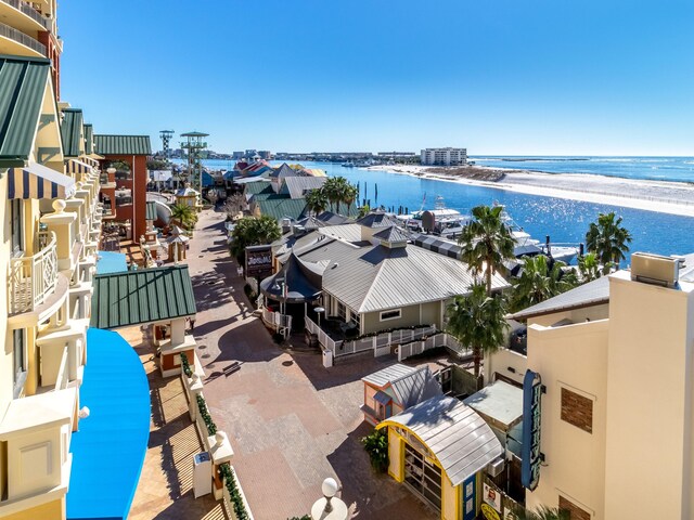 drone / aerial view with a water view and a beach view