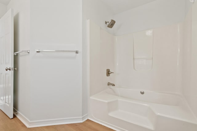 bathroom with shower / bathing tub combination and wood-type flooring