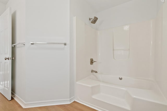 bathroom featuring hardwood / wood-style floors and shower / washtub combination