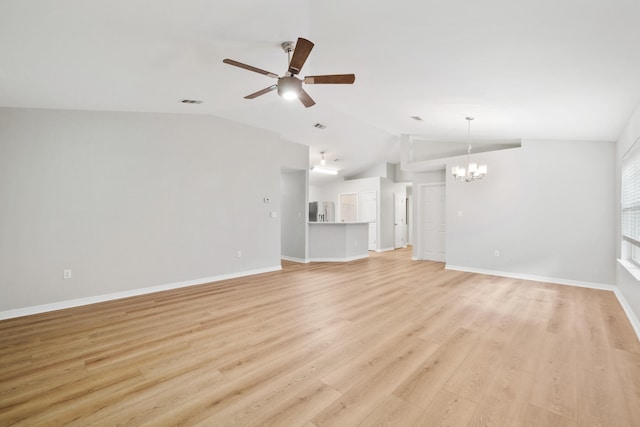 unfurnished living room with lofted ceiling, light hardwood / wood-style floors, and ceiling fan with notable chandelier