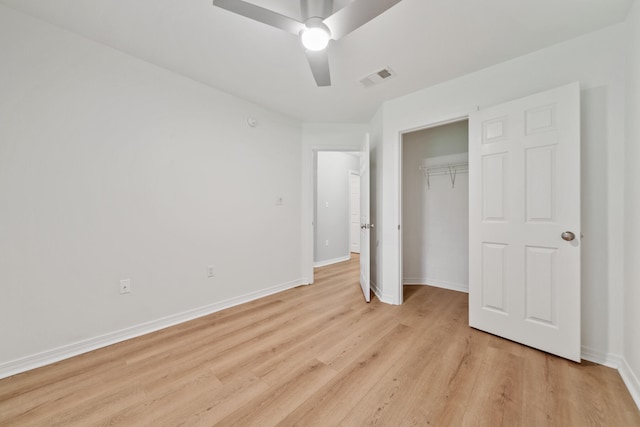 unfurnished bedroom featuring light hardwood / wood-style flooring, a closet, and ceiling fan