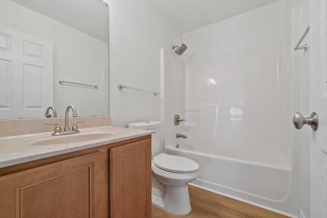 full bathroom with vanity, toilet, hardwood / wood-style floors, and  shower combination