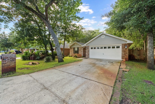 single story home with a garage and a front lawn