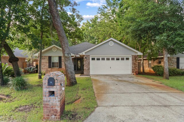 single story home featuring a garage and a front lawn