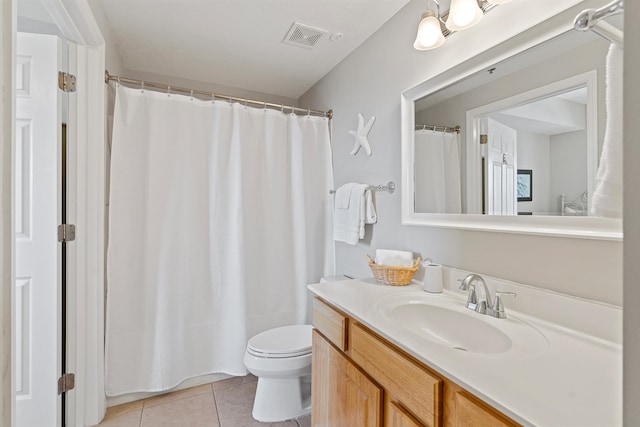 bathroom featuring tile flooring, toilet, and large vanity