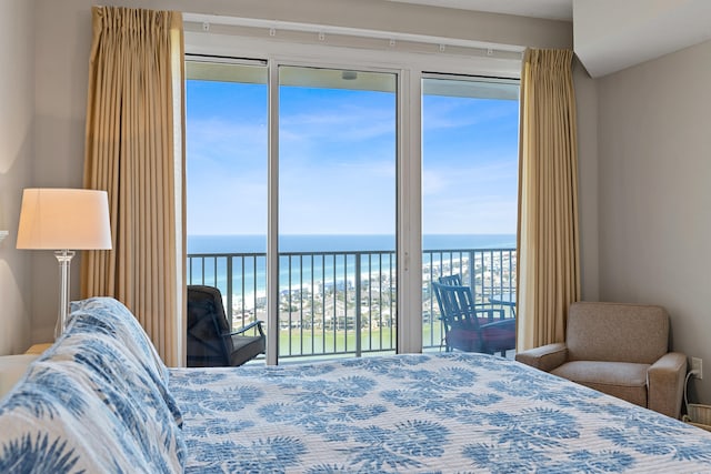 bedroom with a water view and access to exterior