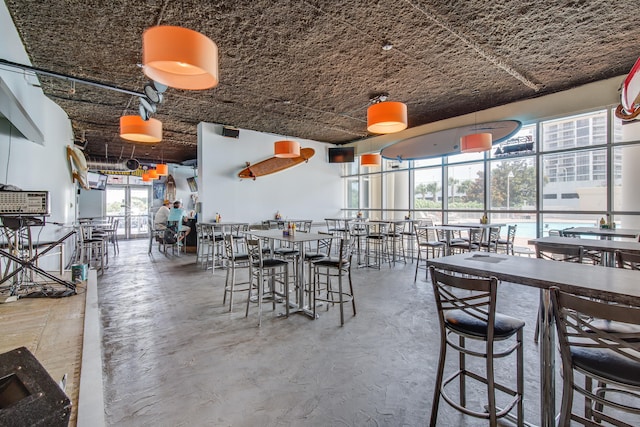 unfurnished dining area featuring concrete flooring