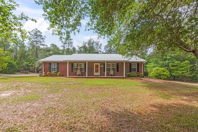 ranch-style house with a porch and a front lawn