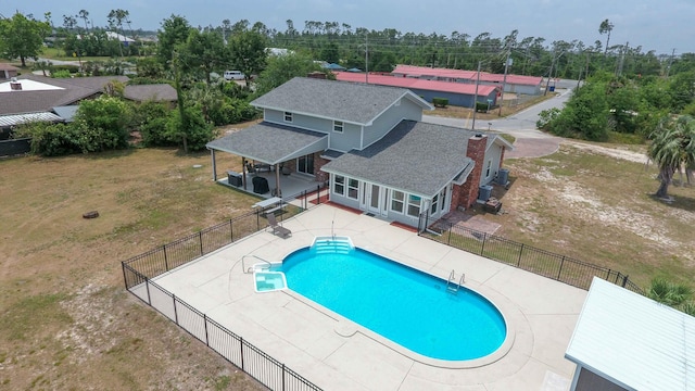 view of pool featuring a lawn and a patio