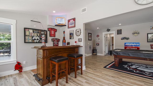 bar featuring light hardwood / wood-style flooring and billiards