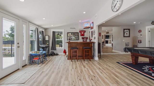 recreation room with a healthy amount of sunlight, lofted ceiling, pool table, and light hardwood / wood-style flooring