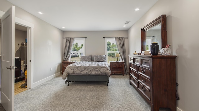 bedroom featuring light colored carpet