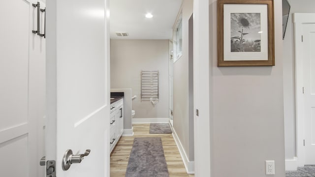 bathroom featuring vanity, hardwood / wood-style flooring, toilet, and a shower with shower door