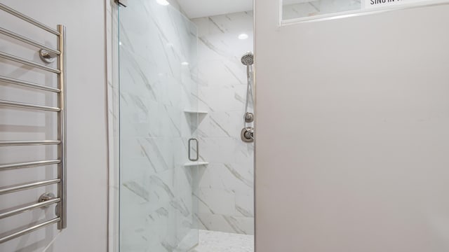 bathroom with radiator and a shower with door