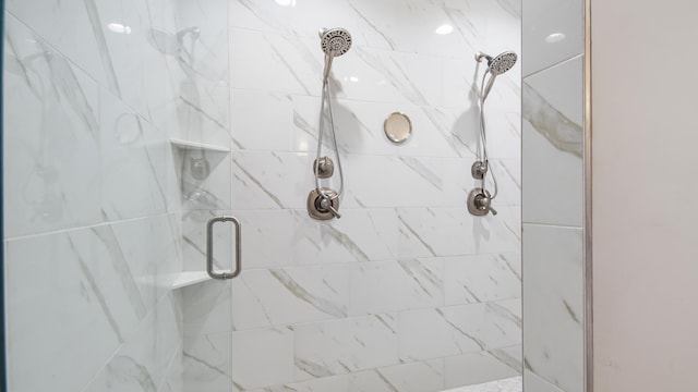 bathroom featuring a shower with shower door