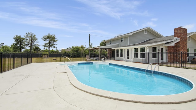 view of swimming pool featuring a patio area and a yard