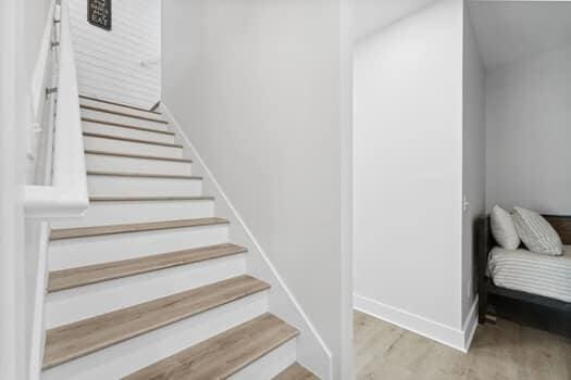 stairs featuring hardwood / wood-style flooring