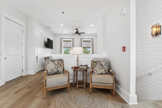 living area featuring ceiling fan and hardwood / wood-style flooring